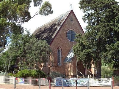 The former McLaren Vale Congregational Church in 2015, now operating as a gallery, brick facade with a steeply pitched slate roof, gallery signage at the fence