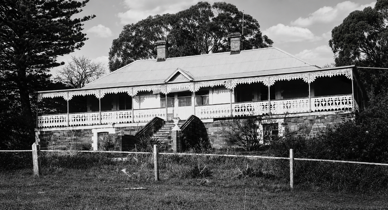 The Aberfoyle homestead at Aberfoyle Park, c.1950s — two-storey stone house with lacework ironwork verandah on both levels