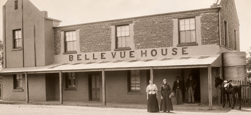 Belle Vue House, McLaren Vale, a two-storey brick hotel with a verandah and the name painted across the facade, two women standing at the entrance
