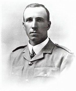 Black-and-white studio portrait of a young man in military uniform, head and shoulders, facing slightly left