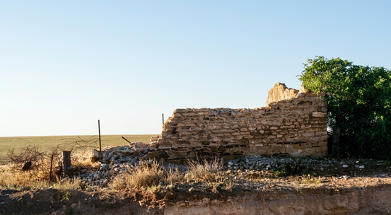 Colour photograph of the Dalkeith Farm ruins, 1984 — collapsed stone walls on a coastal clifftop, the sea visible in the background