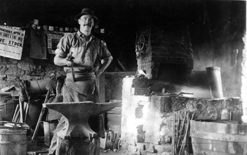 Frank Higgins inside the Higgins blacksmith shop, c.1900
