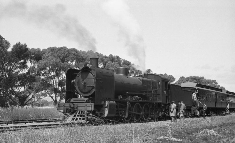 Black-and-white photograph of steam locomotive no. 752 stopped at McLaren Vale station with steam rising from the funnel, passengers boarding the carriages