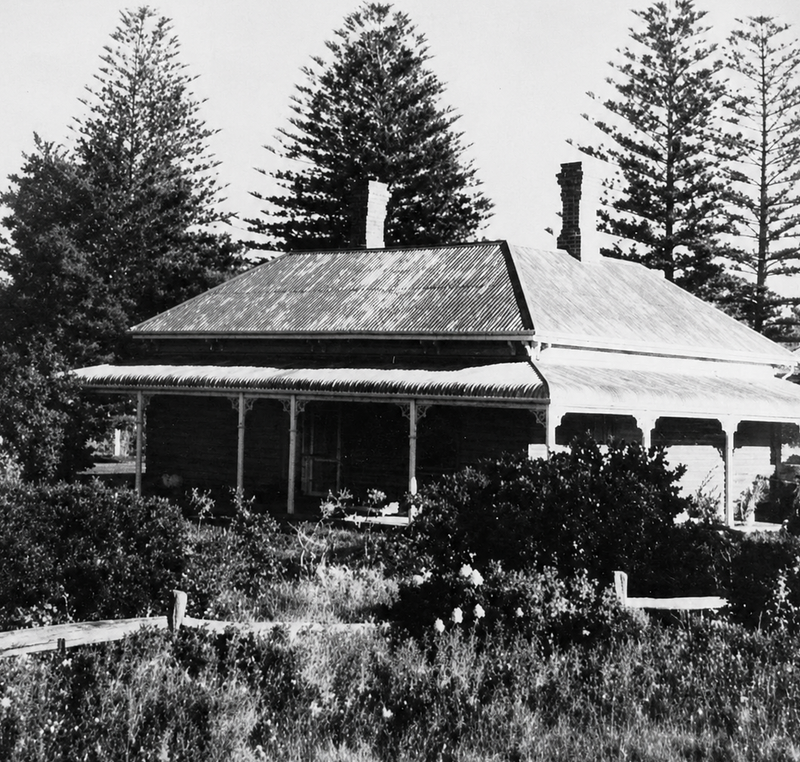 Sauerbier House at 48 Saltfleet Street Port Noarlunga in an early photograph, single-storey Victorian villa with verandah and Norfolk Island pines behind